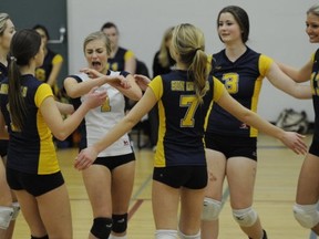 Libero Emma Glennon (white, 1) and the rest of the Quad A South Delta Sun Devils celebrate a point during Tuesday match in Tsawwassen with 2A No. 1 Pacific Academy. (Mark van Manen, PNG)
