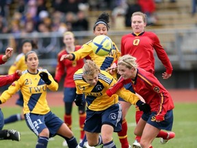 Trinity Western’s Krista Gommeringer (left) challenges Queen’s Alexis McKinty during CIS national final Sunday in Victoria. (Scott Stewart, TWU athletics)