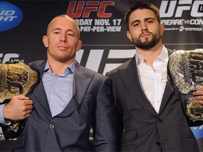 Georges St-Pierre (L) and Carlos Condit will both enter the Octagon with belts on Saturday, but only one will be bringing the hardware home come Sunday morning. (Photo: CP/Ryan Remiorz)
