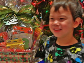 My son with our last minute teacher gift full of all the supplies that a kindergarten teacher could need to make wonderful art!