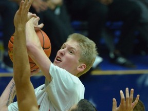 W.J. Mouat's Harley Hansen-Myers tries to battle through the Walnut Grove Gators on Sunday at the LEC. (Submitted photo)