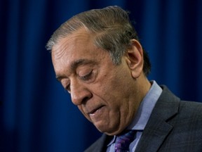 Commissioner Wally Oppal pauses for a moment as he delivers the final report on the findings of the Missing Women Commission in Vancouver on Monday, Dec., 17, 2012. (THE CANADIAN PRESS)