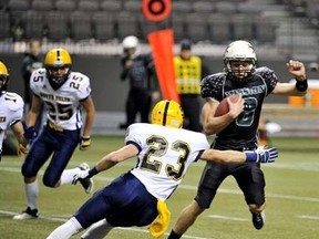 Mission quarterback Kevin Wiens tries to elude the South Delta Sun Devils Saturday at BC Place, in the Double A final. (PNG photo)
