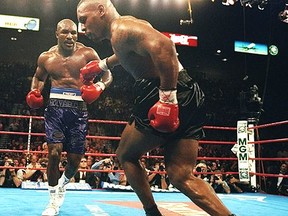 Evander Holyfield charges Mike Tyson in their first fight in 1998, a fight where Holyfield "would not be beaten by a reputation."