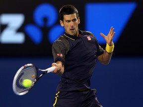MELBOURNE, AUSTRALIA - JANUARY 16:  Novak Djokovic of Serbia plays a backhand in his second round match against Ryan Harrison of USA during day three of the 2013 Australian Open at Melbourne Park on January 16, 2013 in Melbourne, Australia.  (Photo by Julian Finney/Getty Images)