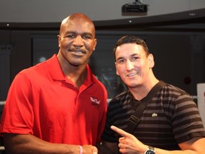 Ring legend Evander "The Real Deal" Holyfield and former Canadian light heavyweight champion Junior "The Real Deal" Moar pose together at the Amanda Todd Anti-Bullying charity dinner monday night. Moar will will going to Uganda May 1 to battle for the WBC International title.