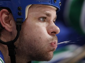 VANCOUVER, CANADA - DECEMBER 30:  Byron Ritchie #15 of the Vancouver Canucks spits out some water as he sits on the bench during their game against the Anaheim Ducks  at General Motors Place on December 30, 2007 in Vancouver, British Columbia, Canada.  The Canucks won 2-1.  (Photo by Jeff Vinnick/NHLI via Getty Images)