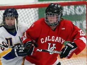UBC's Christi Capozzi (left), a Kelowna native, jostles with Calgary's Jenna Smith during CIS women's hockey action Friday in Calgary. (David Moll, Dinos' athletics)