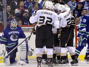 VANCOUVER, CANADA - JANUARY 19: Goalie Cory Schneider #35 of the Vancouver Canucks looks on as Toni Lydman #32 and Francois Beauchemin #23 of the Anaheim Ducks celebrate teammates Kyle Palmieri's #51 (not pictured) goal during the second period in NHL action on January 19, 2013 at Rogers Arena in Vancouver, British Columbia, Canada.  (Photo by Rich Lam/Getty Images)