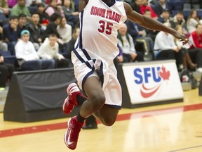 SFU's Elijah Matthews soars to rim for a dunk Saturday in the West Gym. However the Clan lost to visiting Alaska Anchorage. (Ron Hole, SFU athletics)