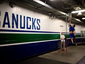 Canucks defenceman Keith Ballard reaches for the sky during medicals and testing Sunday at Vancouver's Rogers Arena.