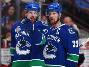 Canucks leaders Henrik and Daniel Sedin point the way to the 2013 TV schedule.