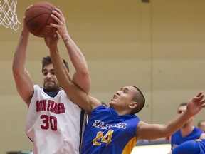 Simon Fraser's Anto Olah grabs one of his ngame-high 11 rebounds as the Clan won its first GNAC game of the season, 68-54 Thursday over Alaska Fairbanks at the West Gym. (Ron Hole, SFU athletics)