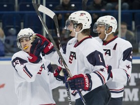 From left to right: John Gaudreau, Jacob Trouba and Seth Jones celebrate one of the U.S.'s many goals in Wednesday's quarterfinal 7-0 win over the Czech Republic. The Americans will meet Canada Thursday morning.