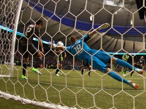 Brad Knighton and Y.P. Lee defend the Whitecaps goal against the Seattle Sounders in 2012. (Getty Images)