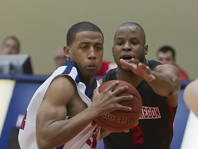 Simon Fraser's Daniel Deflorimonte (left) drives past Western Oregon's Nathaniel Carter during GNAC men's basketball action Thursday at SFU. (Ron Hole, SFU athletics)