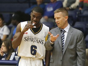 TWU Spartans head coach Scott Allen offers words of wisdom to guard Mark Perrin during the Spartans playoff-clinching win Friday over UBC Okanagan at the Langley Events Centre. (Scott Stewart, Trinity Western athletics)