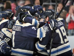 The Columbus Blue Jackets do that happy-guys thing after beating the Vancouver Canucks March 7, 2013 in NHL action.