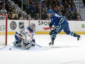 Vancouver Canucks' David Booth beats the Edmonton Oilers' Devan Dubnyk for a rare goal on April 7, 2012.