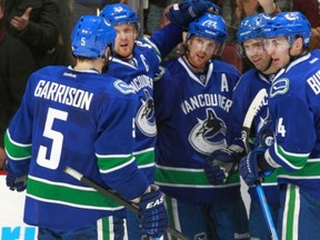 Henrik Sedin, second from left, seems like he's struggling to explain the Canucks woes these days. (Photo: Jeff Vinnick/Getty Images)