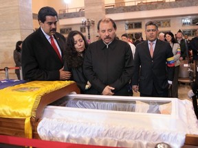 Nicaraguan President Daniel Ortega views the body of former Venezuelan president Hugo Chavez in Caracas on Friday, possibly wondering if his country will have him embalmed and put on permanent display, too, like Lenin, when he dies. (AFP)