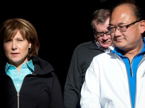 Premier Christy Clark and former multiculturalism minister John Yap walk together during an announcement at Kwantlen Polytechnic University in Richmond in December. (THE CANADIAN PRESS FILES)