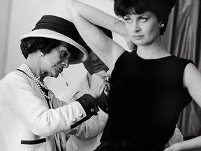 Coco Chanel fitting a model in her studio