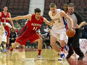 UBC's Conor Morgan (right) battles to stay in bounds under pressure from the Acadia Axemen in Friday's CIS Final 8 opening-round contest. UBC lost and faces Victoria in the consolation round today. (Richard Lam, UBC athletics)