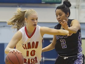 Simon Fraser’s Kristina Collins (left) dribbles past Justine Johnson of Grand Canyon University during Western Regional semifinal action Tuesday afternoon at Sam Carver Gymnasium on the campus of Western Washington University in Bellingham, Wash. (Photo – Ron Hole, SFU athletics)