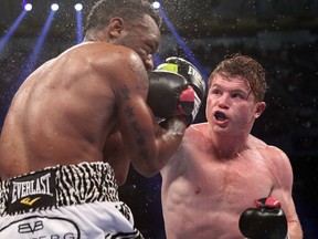 Saul Alvarez, right, lands a solid right hand on Austin Trout in their championship unification bout Saturday night. Photo: Tom Casino-Stephanie Trapp/SHOWTIME