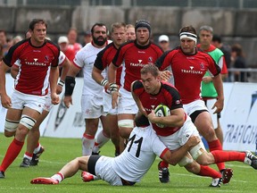 Hotson (centre, with scrum cap) running in support of Rugby Canada teammate Jebb Sinclair (carrying ball) (Judy Teasdale photo)