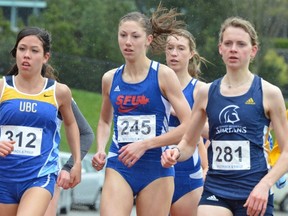 Simon Fraser's Helen Crofts (centre, 245), flanked by UBC's Maria Bernard (left) and Fiona Benson of Trinity Western, beat the rain and the rest of the pack to win the 1,500 metres at the Achilles meet staged Sunday at SFU's own Terry Fox Field.
