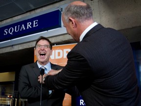 NDP Leader Adrian Dix, left, reacts as Port Coquitlam NDP candidate Mike Farnworth adjusts his tie before speaking at a provincial election campaign stop at Robson Square in Vancouver on Monday April 29, 2013. (THE CANADIAN PRESS)