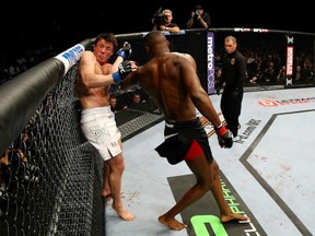 Chael Sonnen narrowly avoids a Jon Jones spinning elbow attack during their championship encounter at UFC 159.