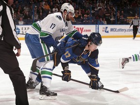 The Vancouver Canucks' Ryan Kesler and St. Louis Blues' Vladimir Sobotka Tuesday night at Scottrade Center. Getty Images photo.