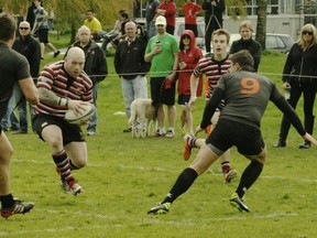 Castaway-Wanderers hooker Ray Barkwill looks for a gap between Meraloma defenders Eric Harland and Greg Perih in CDI Premier League action at Connaught Park on April 20, 2013 (Patrick Johnston photo)