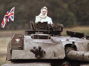 British Prime Minister Margaret Thatcher stands in a British tank during a visit to British forces in Fallingbostel, some 120 km (70 miles) south of Hamburg, Germany, on Sept. 17, 1986. (AP Photo/Jockel Fink)