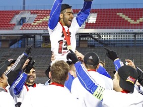 UBC’s Gagan Dosanjh takes his turn hoisting the national championship trophy after the Thunderbirds won the CIS title earlier this season. On Wednesday, Dosanjh was named UBC’s Male Athlete of the Year. (Photo – Yan Doublet, Laval athletics)