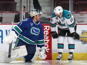 The Vancouver Canucks' Roberto Luongo and the San Jose Sharks' Joe Thornton kibbitz before a 2011 game. Getty Images file photo.
