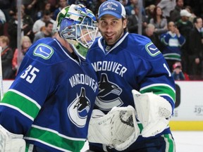 Who starts? Cory Schneider, left, or Roberto Luongo? (Photo: Jeff Vinnick/Getty Images)