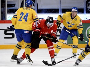 Alexr Edler (L) hits Canada's Eric Staal during the quarterfinal match between Canada and Sweden at the 2013 IIHF Ice Hockey World Championships on Thursday. (Photo: JONATHAN NACKSTRAND/AFP/Getty Images)