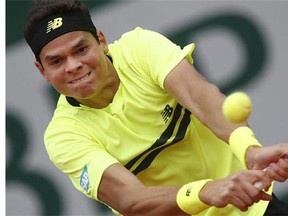 Canada's Milos Raonic returns against Belgium's Xavier Malisse in their first round match of the French Open tennis tournament, at Roland Garros stadium in Paris, Sunday, May 26, 2013. (AP Photo/Petr David Josek)