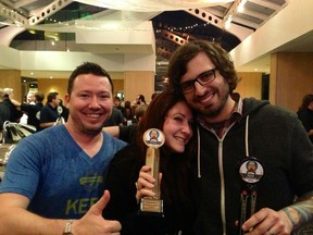 David Bowkett (right) and wife Nicole of Powell Street Craft Brewery with their CBA trophies. Daniel Collins of Hops Connect (left) gives his approval.