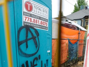 Anarchist graffiti on the site of a suspected arson attack on East 1st Avenue near Victoria Drive in Vancouver on May 16, 2013. (Nick Procaylo/PNG FILES