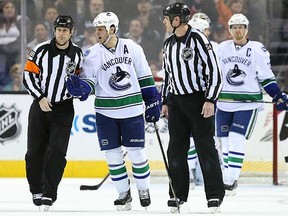 Kevin Bieksa complains to the referee after his dubious cross-checking penalty late in the third period. (Christian Petersen/Getty Images)