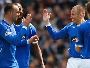 Kris Boyd (left) says his longtime pal Kenny Miller, the Whitecaps forward, wants to return to Rangers. Here, the former Rangers and Scotland teammates celebrate a Scottish Cup semifinal goal. (Getty Images)