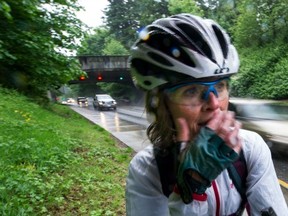 Cyclist Helen Brown talks about safety along the Stanley Park Causeway as heavy traffic roars by. There was a fatal accident involving a bus and cyclist last week. (Steve Bosch/PNG FILES)