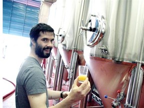 Head brewer Brent Mills of Four Winds Brewing Co. taps a sample of Four Winds Saison.