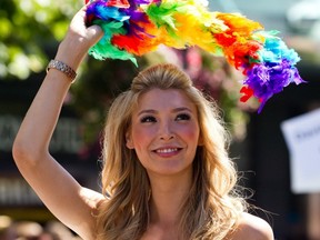 Vancouver Pride Parade grand marshal Jenna Talackova, the first transgendered Miss Universe contestant, waves to crowd during the event in August. (THE CANADIAN PRESS FILES)