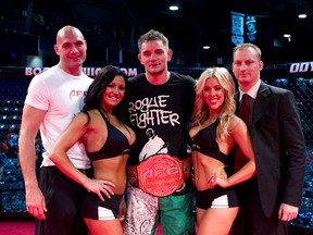 Starnes alongside a pair of ring girls and AFC co-presidents Jason Heit (left) and Darren Owen (right) during his stint as AFC middleweight champion. (Photo courtesy of Aggression Fighting Championship)